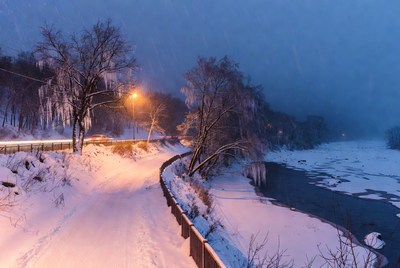 Snowy Road by Frozen River at Night