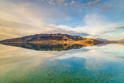 Mountains reflected in turquoise lake