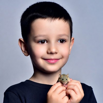 Boy holding cute hamster