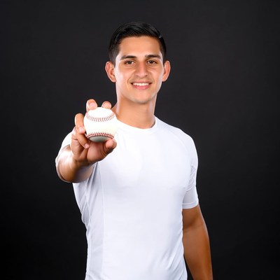 Young Latino man holding baseball