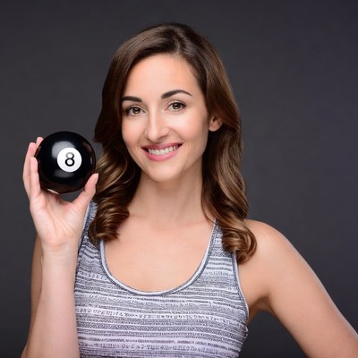 Woman holding black 8 ball