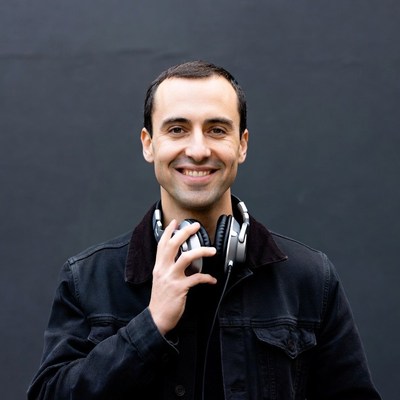 Man holding headphones smiling