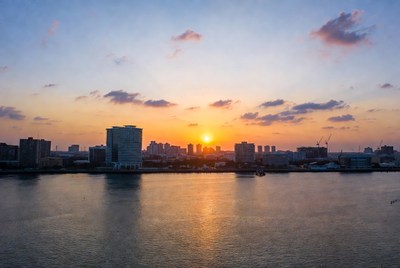 Sunset over city skyline and river
