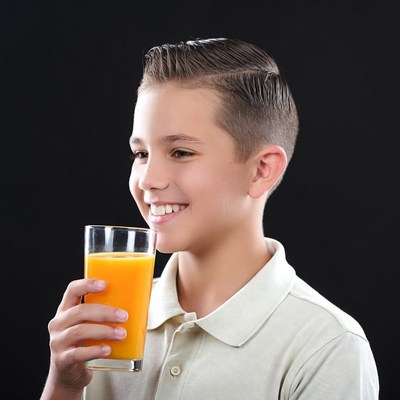 Boy drinking orange juice