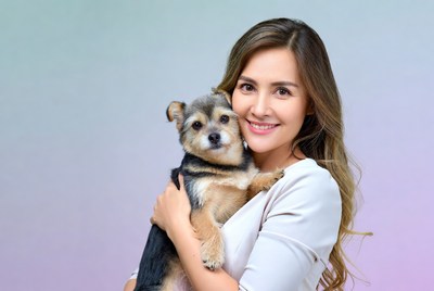 Woman hugging small dog