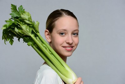 Girl holding celery stalk