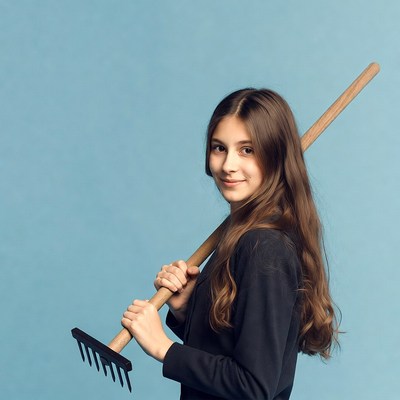 Girl holding garden rake