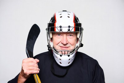 Senior man in hockey goalie gear