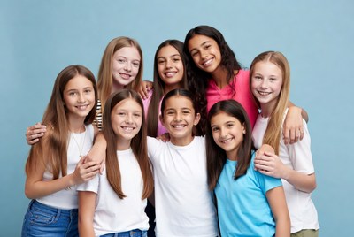 Group of smiling teenage girls hugging