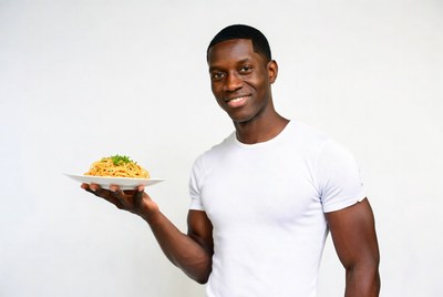 African-American man holding spaghetti plate