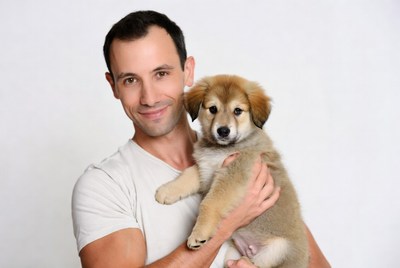 Man holding fluffy puppy