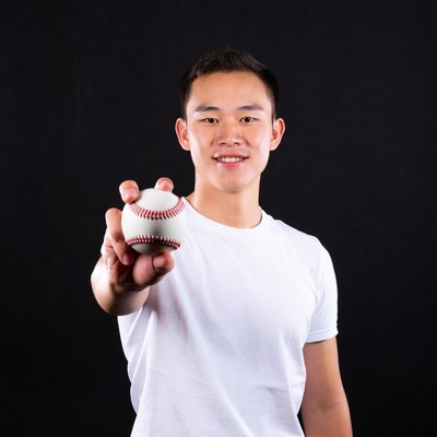 Asian man holding baseball
