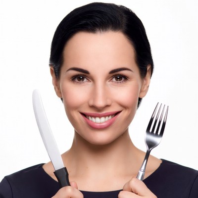 Woman holding knife and fork