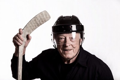 Elderly man holding hockey stick