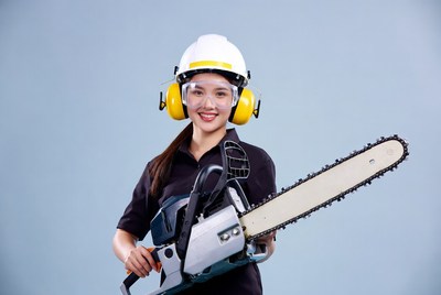 Asian woman holding chainsaw
