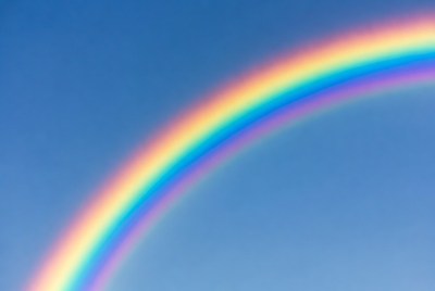 Vibrant Rainbow in Blue Sky