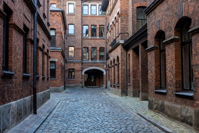 Narrow Cobblestone Alley in Brick Buildings