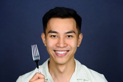 Asian man holding fork