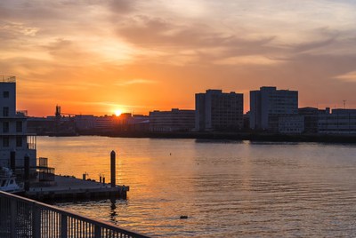 Sunset over city skyline and river