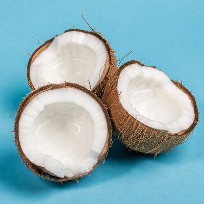 Three Split Coconuts on Blue Background