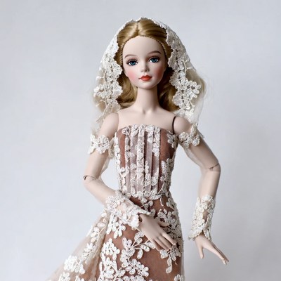 Blonde doll in lace wedding gown