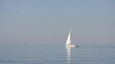 White sailboat on calm sea