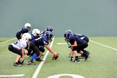 Football players in huddle on field