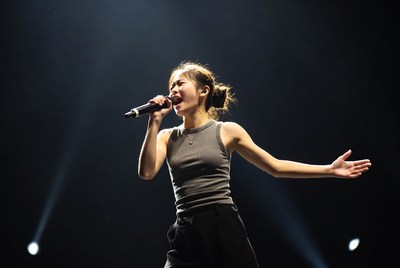 Asian woman singing on stage