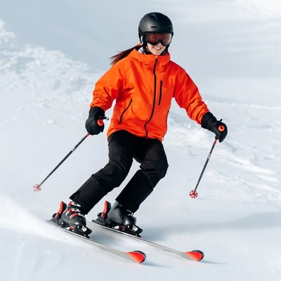 Woman skiing down snowy slope