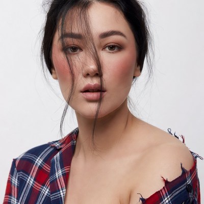 Asian woman in plaid shirt portrait