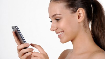Woman smiling using smartphone