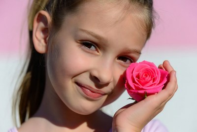Girl holding pink rose