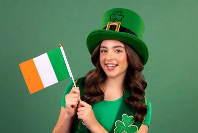 Girl in shamrock hat holding Irish flag