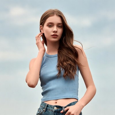 Young woman in blue tank top outdoors