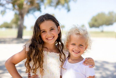 Two smiling girls outdoors