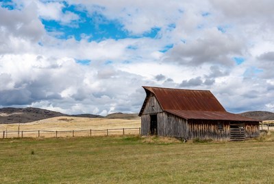 Rustic red barn in grassy field