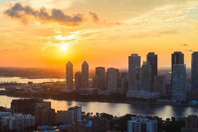 Sunset over city skyline with river