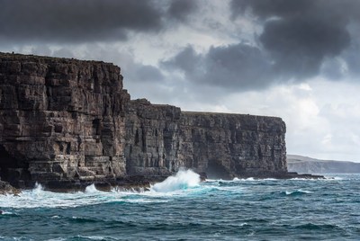 Stormy Sea Crashing Against Tall Cliffs