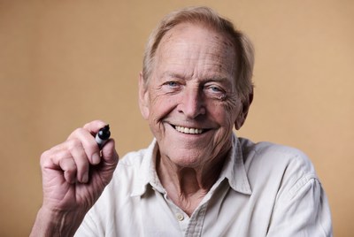 Smiling elderly man holding marker