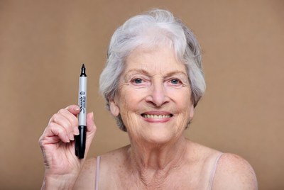 Elderly woman holding black marker