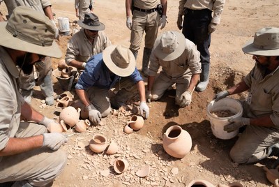 Archaeologists Excavating Ancient Pottery