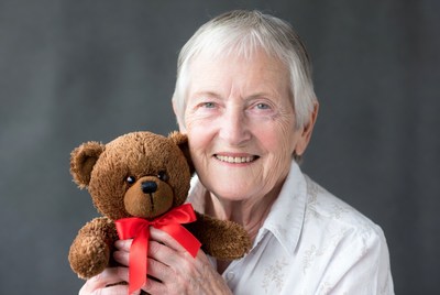Elderly woman holding teddy bear