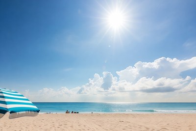 Blue Striped Umbrella on Sunny Beach