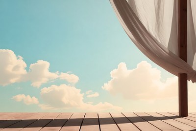 White curtain on wooden deck overlooking sky
