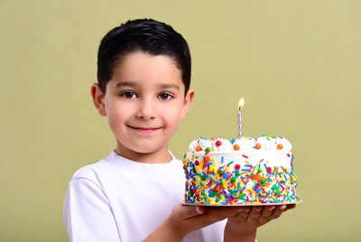 Boy holding birthday cake