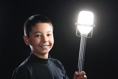 Boy holding vintage microphone