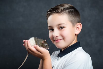 Boy holding white rat