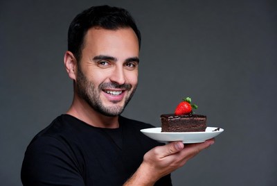 Man holding chocolate brownie with strawberry