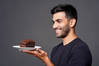 Man holding chocolate brownie