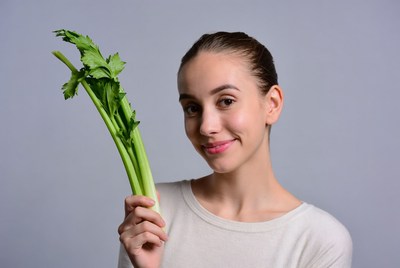 Girl holding fresh celery